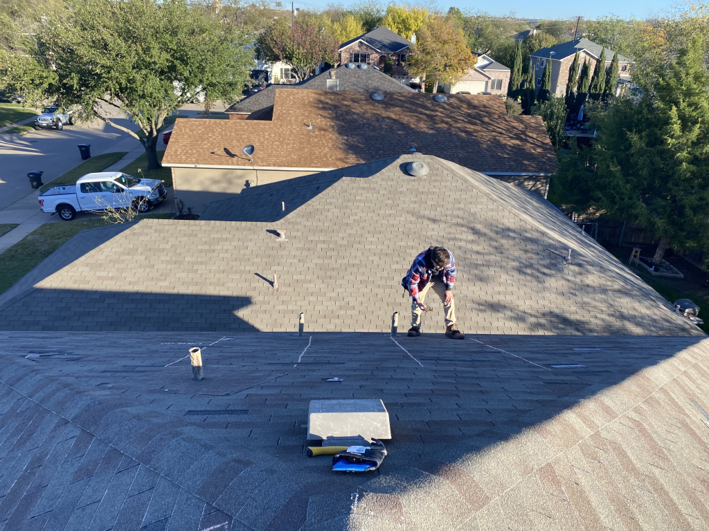 NLRC team member inspecting a residential roof in DFW