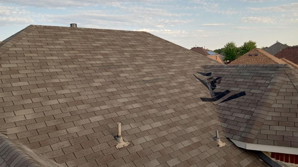 Wind-damaged shingles documented for leak-fix work near historic Main Street in Grapevine TX