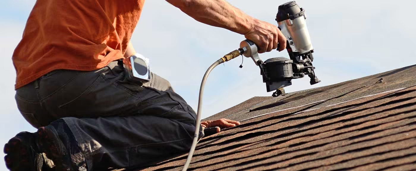 NLRC roofer fastening shingles on a residential roof